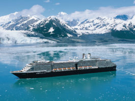 holland america cruise ship in alaska with ice capped mountains