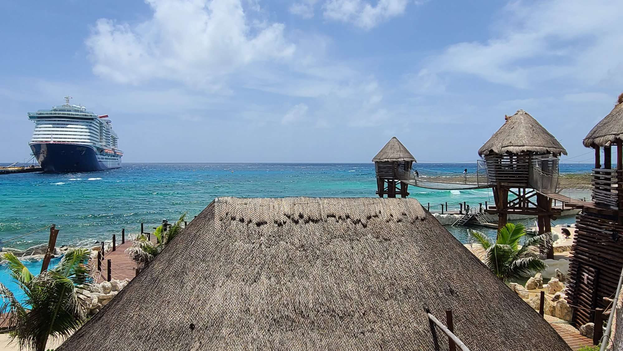 costa maya cruise ship in port with huts along beach