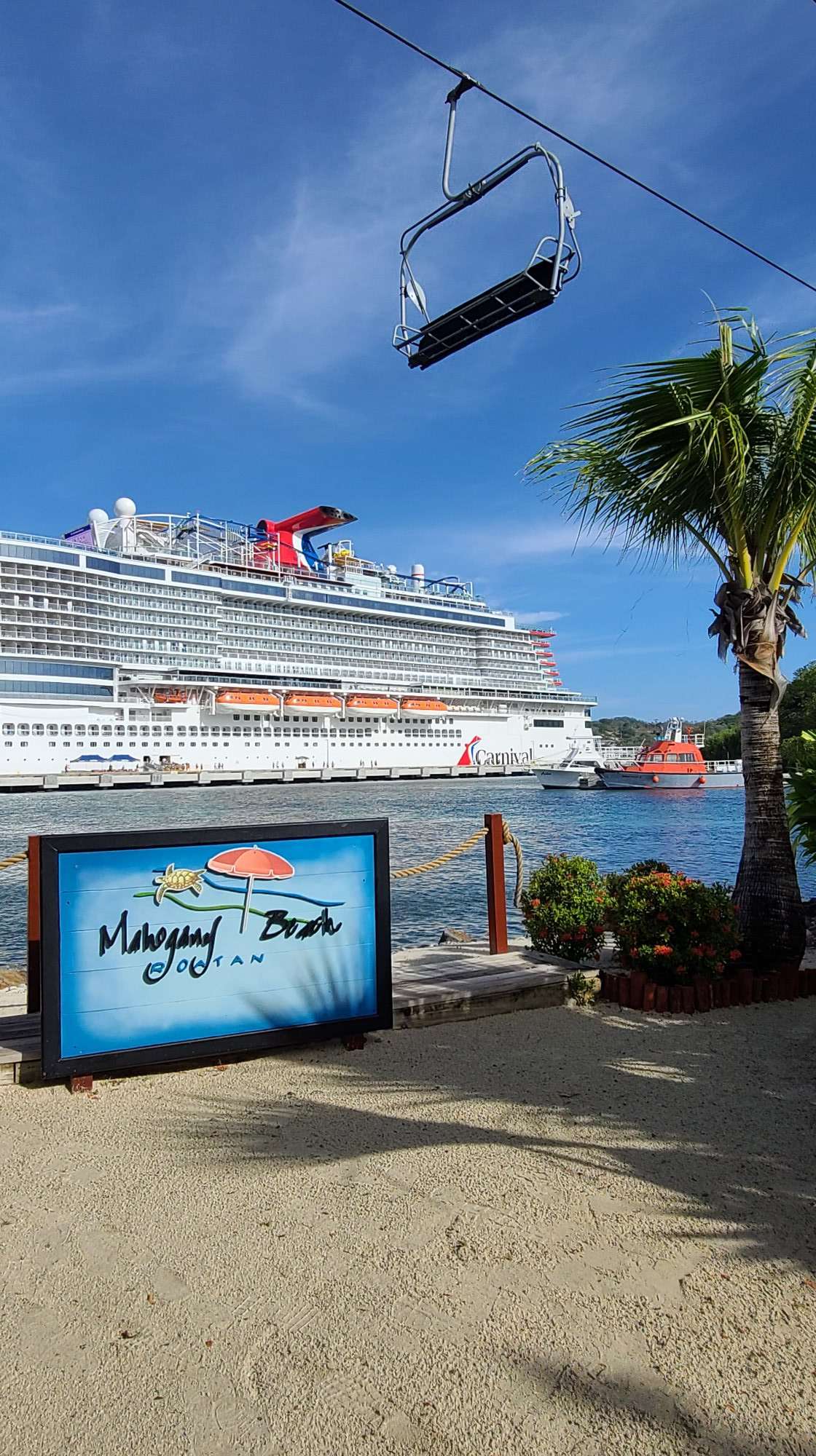 Carnival cruise ship in port with Mahogany Bay sign