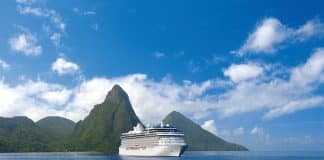 oceania cruise ship with mountains behind it