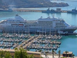 silversea luxury cruise ship in port by boats at marina