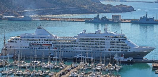 silversea luxury cruise ship in port by boats at marina