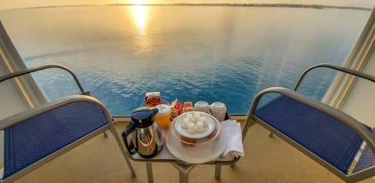 norwegian escape balcony with room service breakfast at sunrise