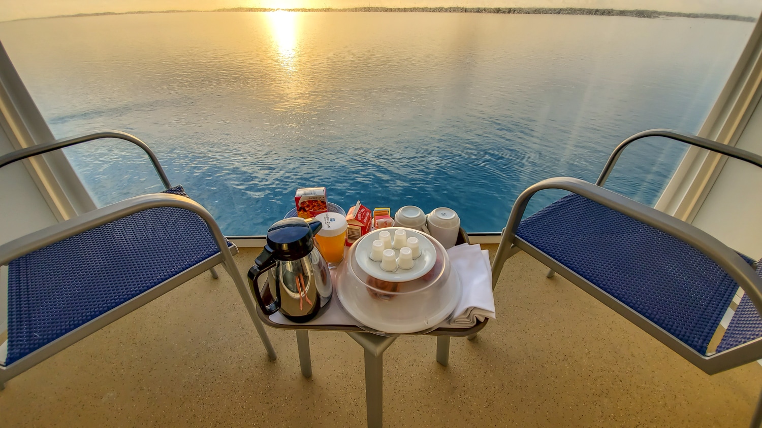 norwegian escape balcony with room service breakfast at sunrise