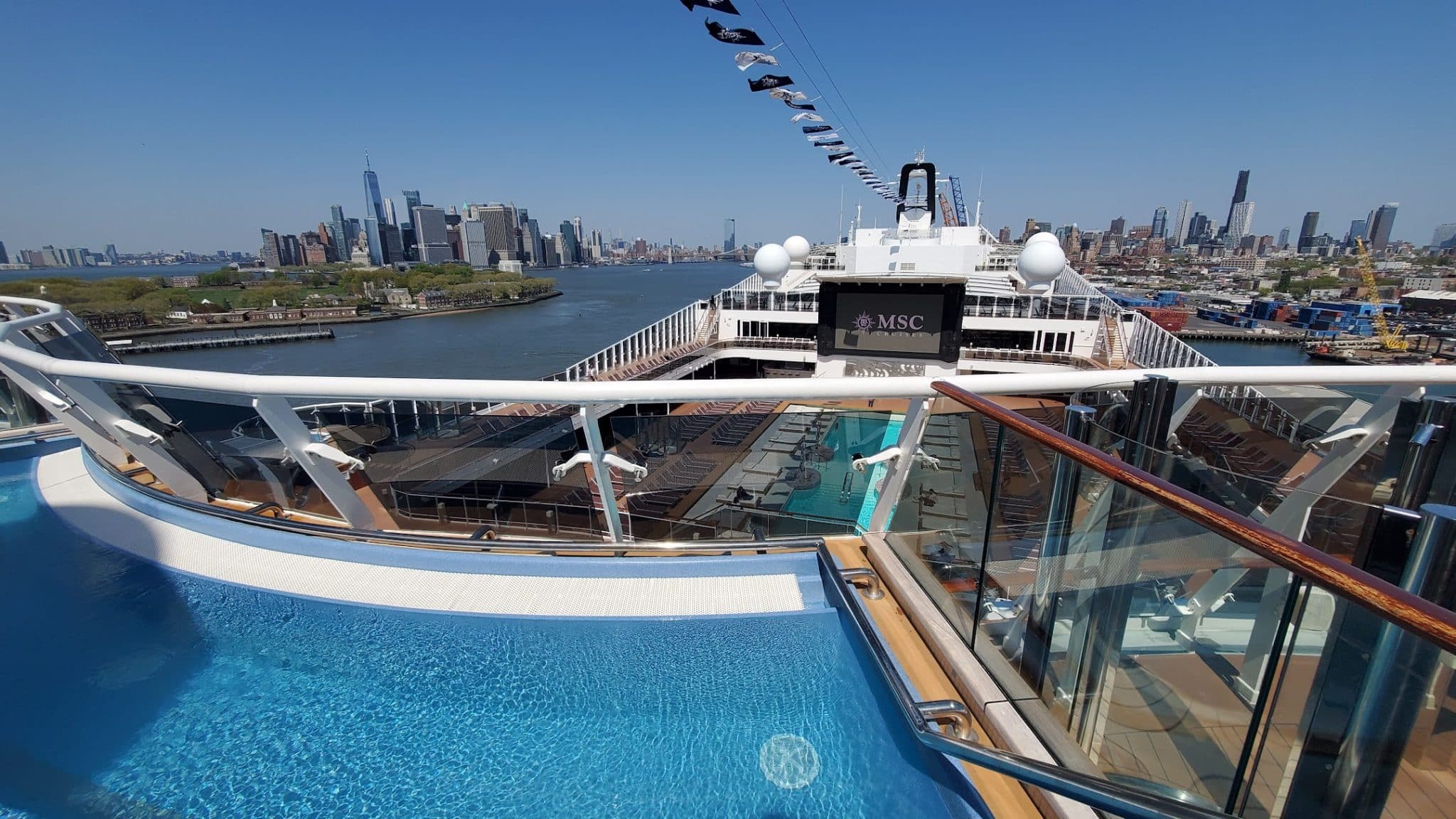 Top pool on MSC Meraviglia showing New York City from Brooklyn cruise port