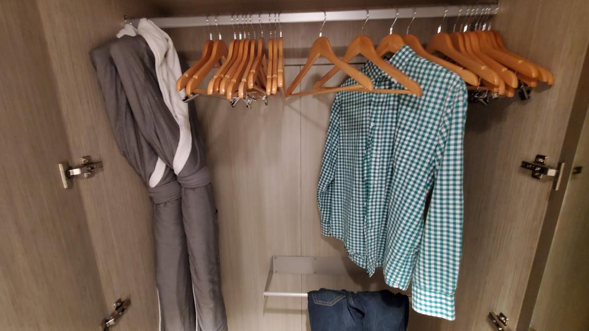 Cruise cabin closet with hangers and robe