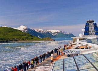 celebrity cruise ship in Alaska with people looking at the views on deck