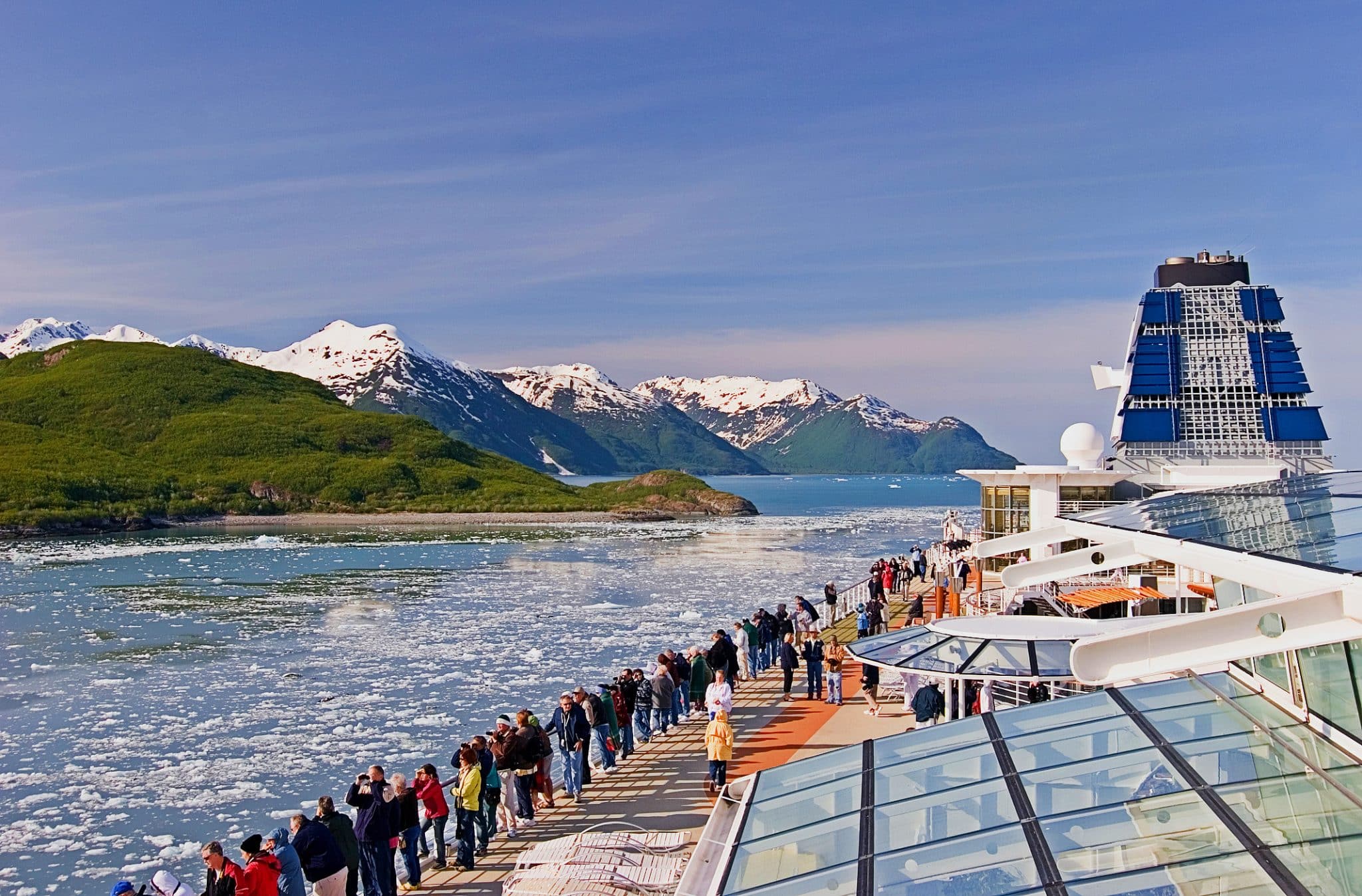 celebrity cruise ship in Alaska with people looking at the views on deck