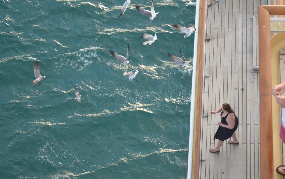 woman throwing things overboard a cruise ship