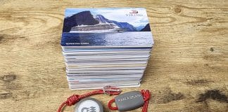 A pile of old cruise cards and princess medallions