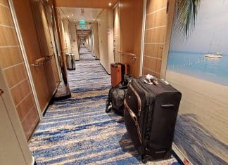 Suitcase and luggage in cruise ship hallway in front of cabins