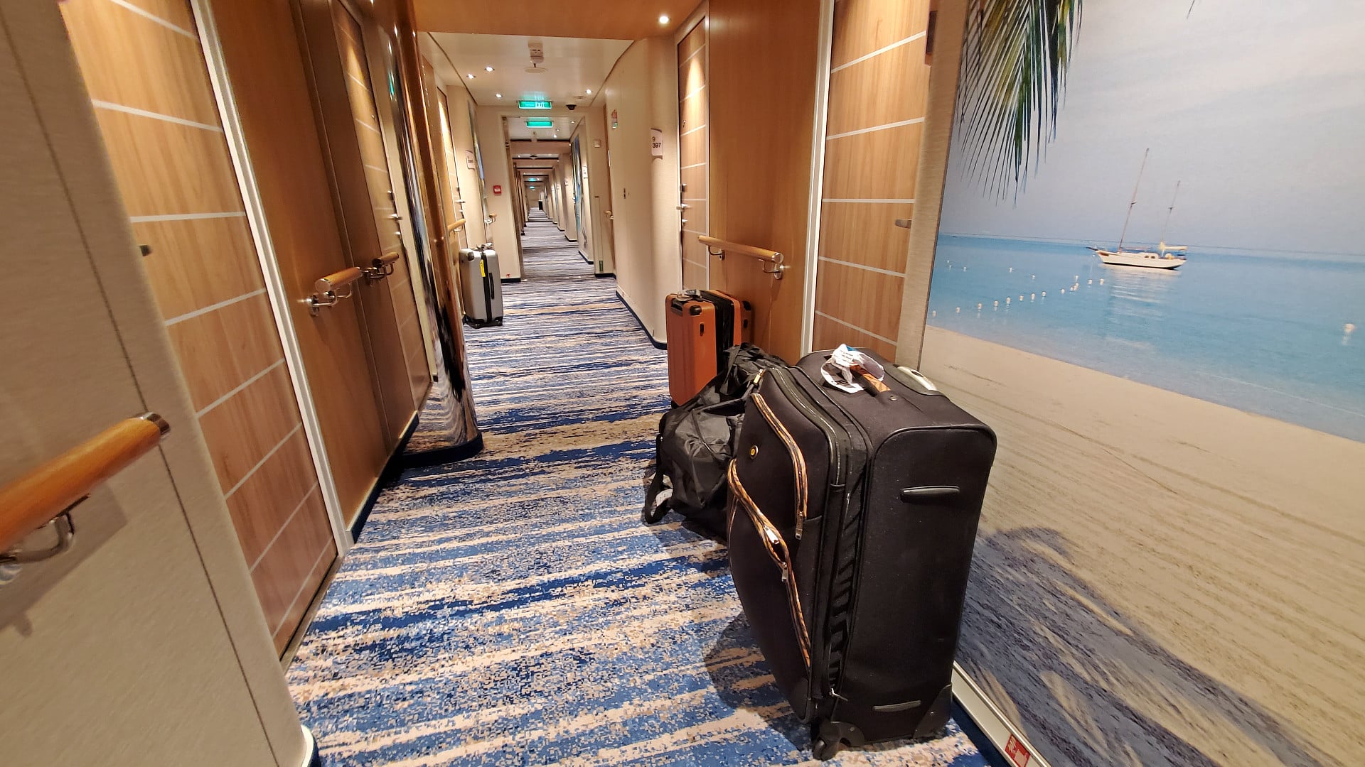 Suitcase and luggage in cruise ship hallway in front of cabins