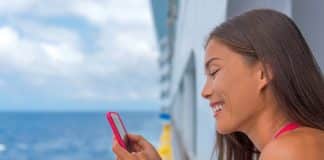 woman with cell phone on cruise ship