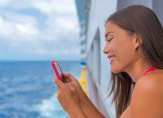 woman with cell phone on cruise ship