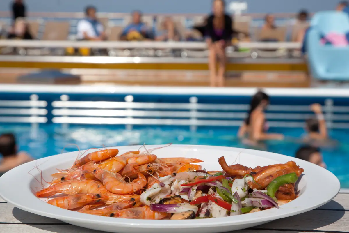 Food plate on a cruise ship with pool in background