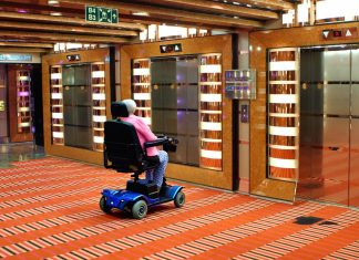 woman on mobility scooter by elevator on Carnival Cruise Line ship