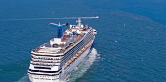 Carnival Conquest sailing out to sea from port