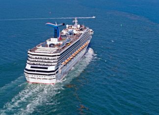 Carnival Conquest sailing out to sea from port