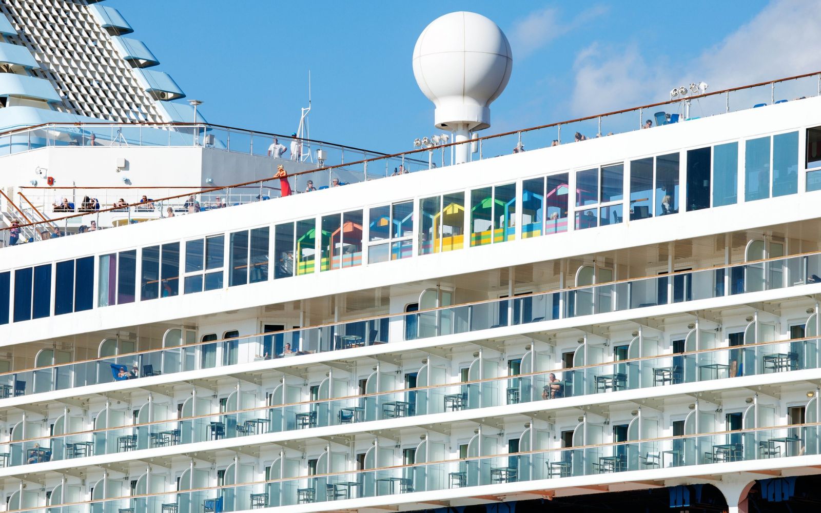 Rows of balconies on a large modern cruise ship at sea