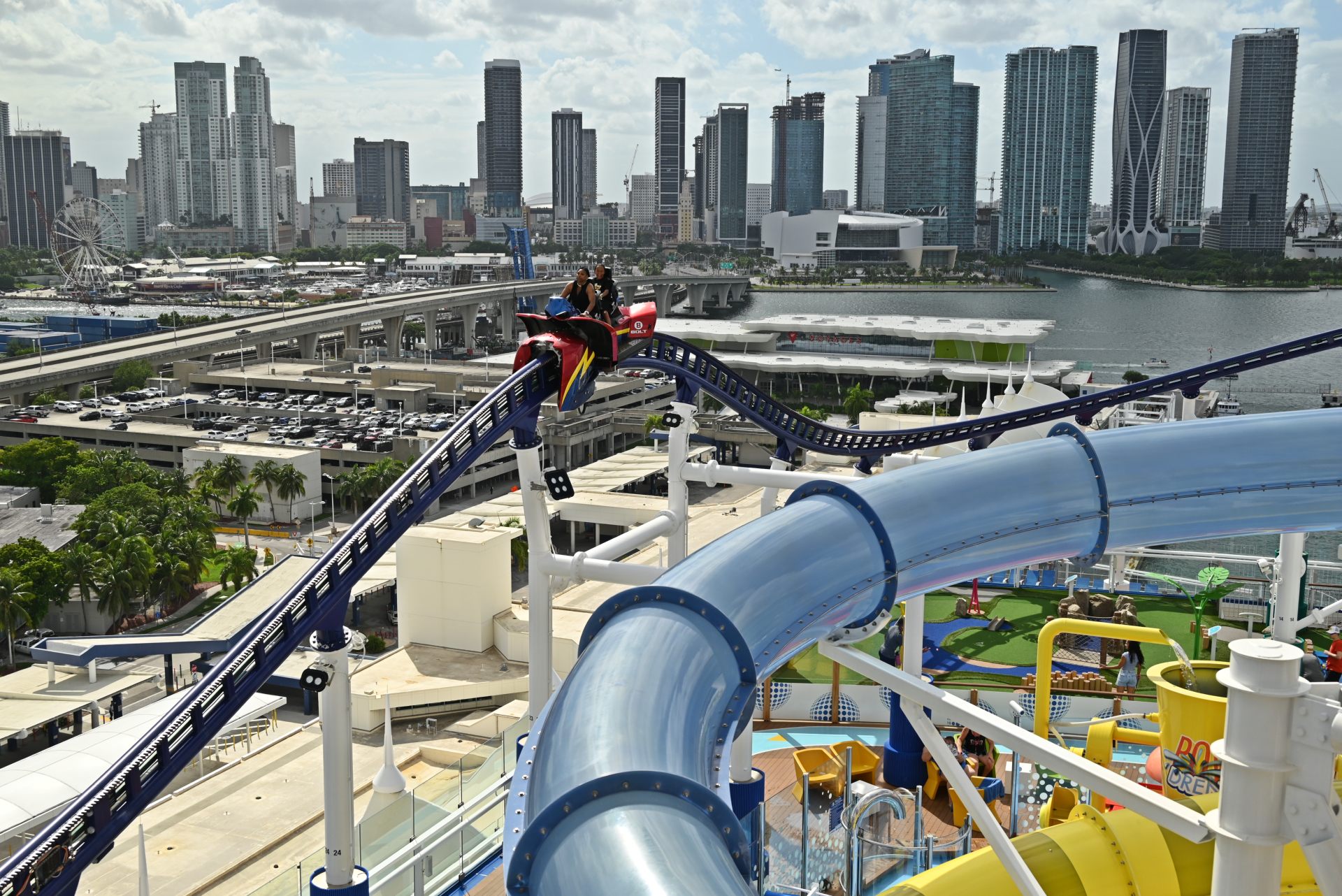 Carnival cruise ship roller coaster with Miami city skyline background
