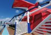 Carnival cruise line ship's whale tail on top deck with city in background