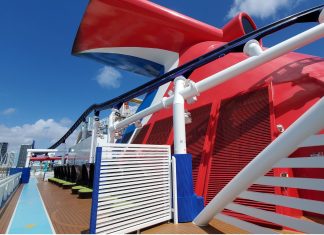 Carnival Sends Reminder for VIFP Cruisers to “Enroll and Accept” Before September Deadline Carnival cruise line ship's whale tail on top deck with city in background